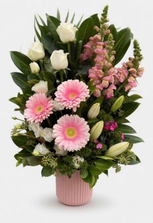 Large mixed flower arrangement in ceramic vase roses lilies gerberas snapdragons